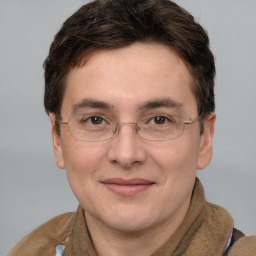 Joyful white adult male with short  brown hair and grey eyes