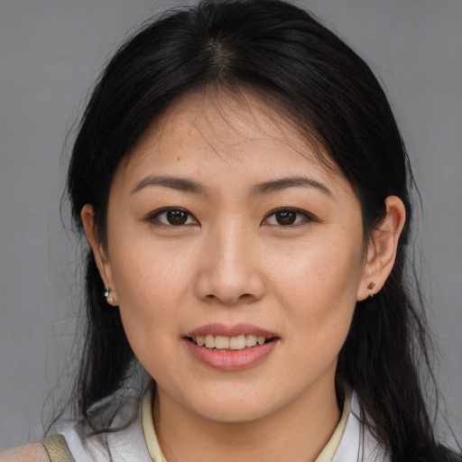 Joyful asian young-adult female with medium  brown hair and brown eyes