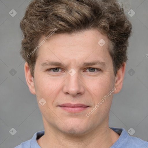 Joyful white adult male with short  brown hair and grey eyes