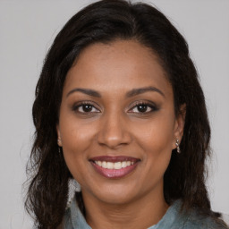 Joyful black young-adult female with medium  brown hair and brown eyes