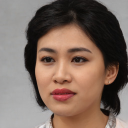 Joyful asian young-adult female with medium  black hair and brown eyes