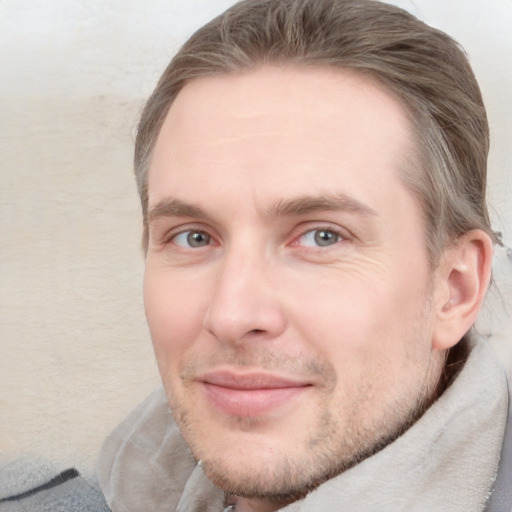 Joyful white adult male with short  brown hair and grey eyes