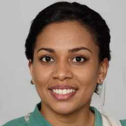 Joyful latino young-adult female with short  brown hair and brown eyes