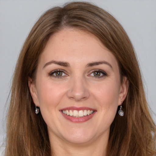 Joyful white young-adult female with long  brown hair and brown eyes