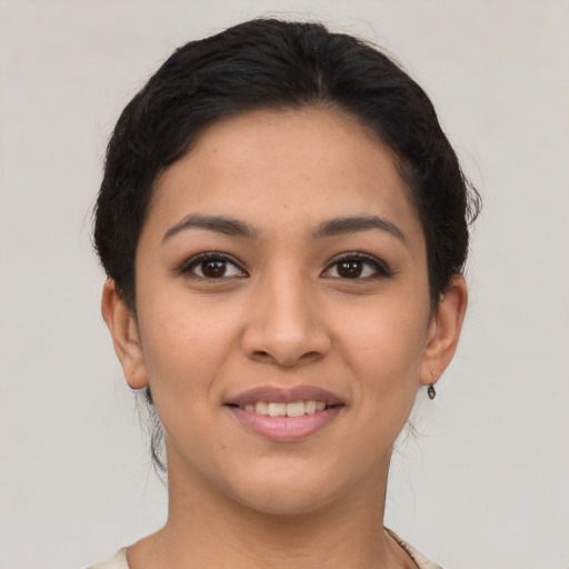 Joyful latino young-adult female with short  brown hair and brown eyes