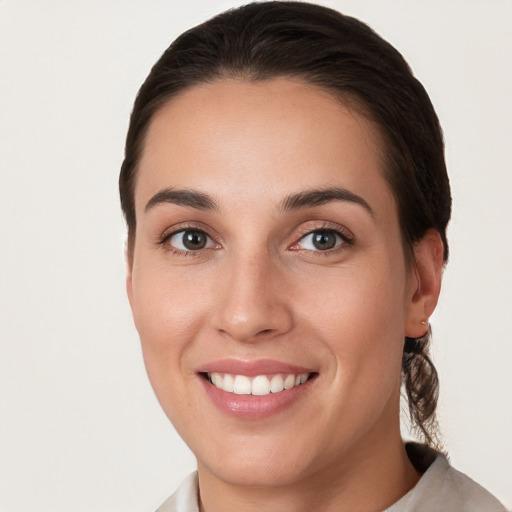 Joyful white young-adult female with medium  brown hair and brown eyes