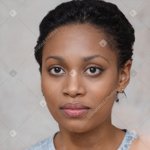 Joyful black young-adult female with short  black hair and brown eyes