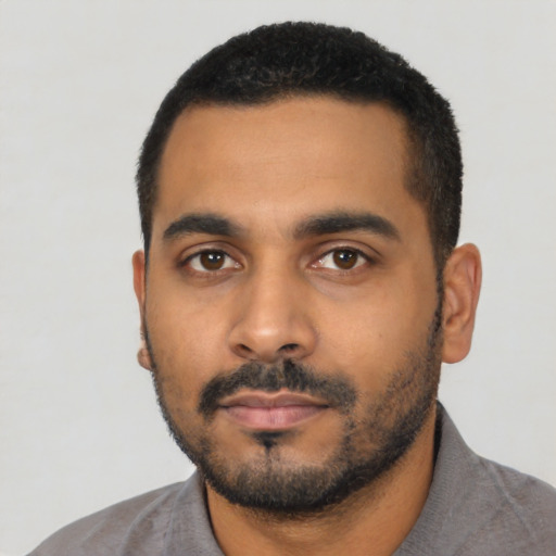 Neutral latino young-adult male with short  black hair and brown eyes