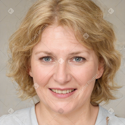 Joyful white adult female with medium  brown hair and blue eyes