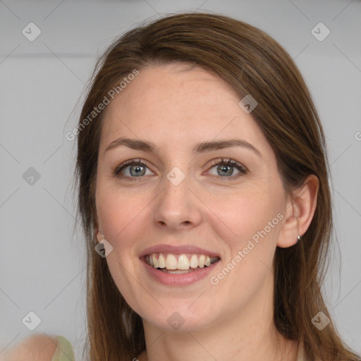 Joyful white young-adult female with long  brown hair and blue eyes