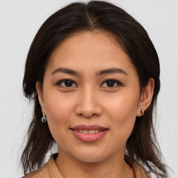 Joyful asian young-adult female with medium  brown hair and brown eyes