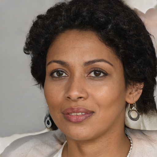 Joyful black young-adult female with medium  black hair and brown eyes