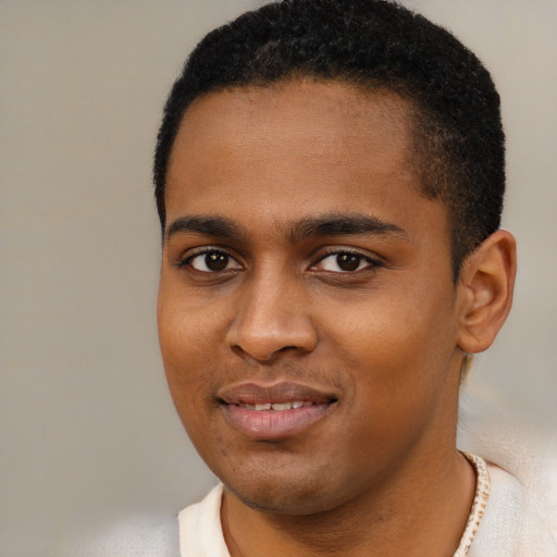 Joyful black young-adult male with short  black hair and brown eyes