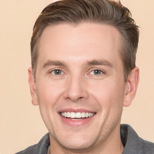 Joyful white adult male with short  brown hair and brown eyes