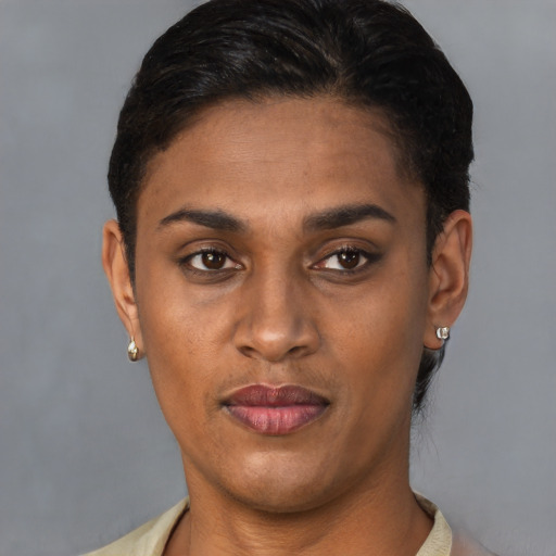 Joyful latino young-adult female with short  brown hair and brown eyes
