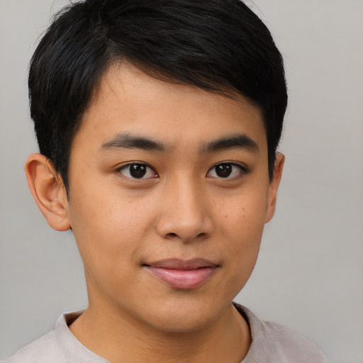 Joyful asian young-adult male with short  brown hair and brown eyes
