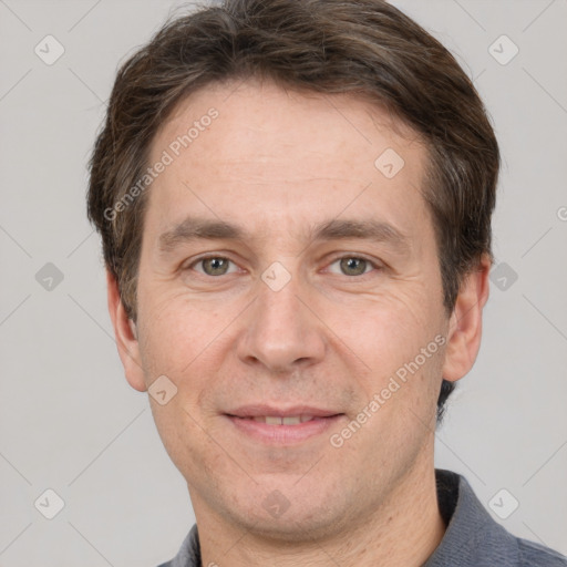 Joyful white adult male with short  brown hair and grey eyes