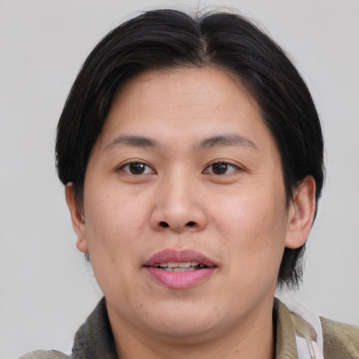 Joyful asian young-adult male with medium  brown hair and brown eyes