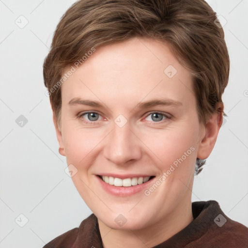 Joyful white young-adult female with short  brown hair and grey eyes