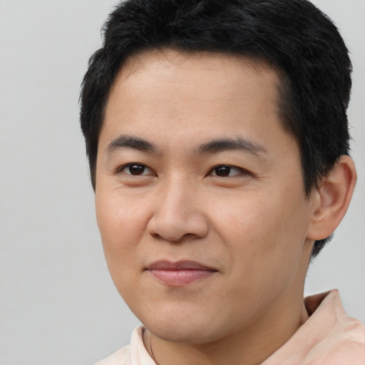 Joyful latino young-adult male with short  brown hair and brown eyes
