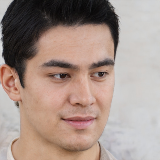 Joyful asian young-adult male with short  brown hair and brown eyes