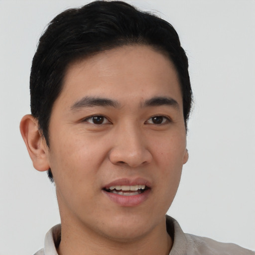 Joyful white young-adult male with short  black hair and brown eyes
