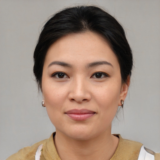 Joyful asian young-adult female with medium  brown hair and brown eyes