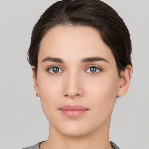 Neutral white young-adult female with short  brown hair and brown eyes