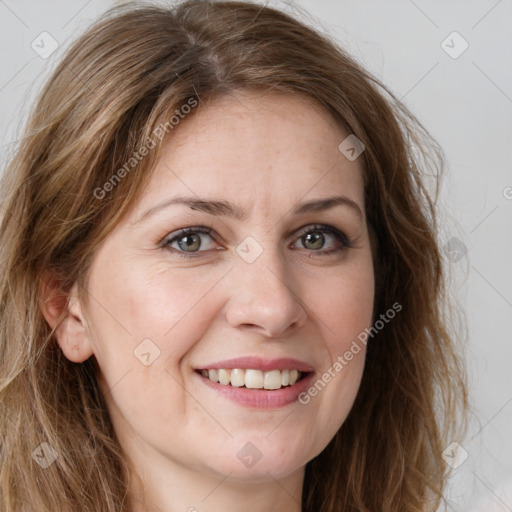 Joyful white adult female with long  brown hair and green eyes