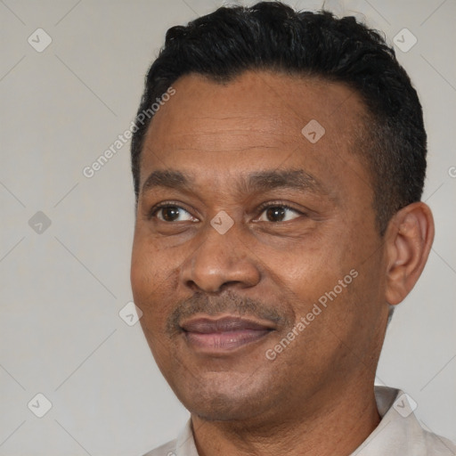 Joyful black adult male with short  black hair and brown eyes