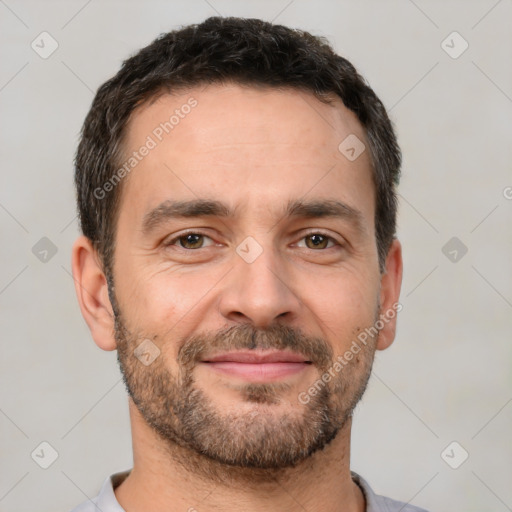 Joyful white adult male with short  brown hair and brown eyes