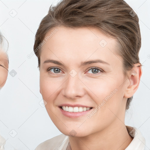 Joyful white young-adult female with short  brown hair and grey eyes