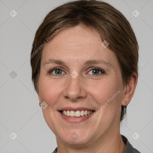 Joyful white adult female with short  brown hair and grey eyes