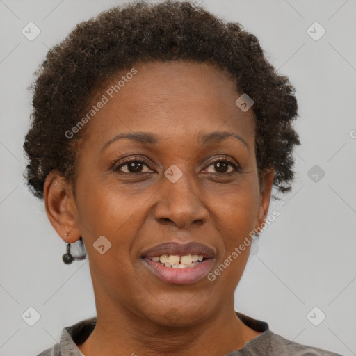 Joyful black adult female with short  brown hair and brown eyes