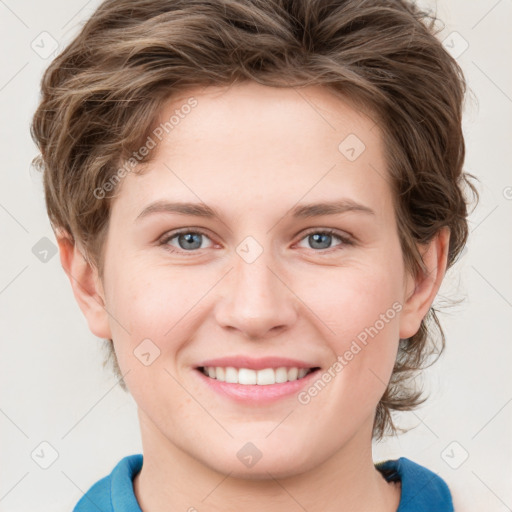 Joyful white young-adult female with medium  brown hair and blue eyes