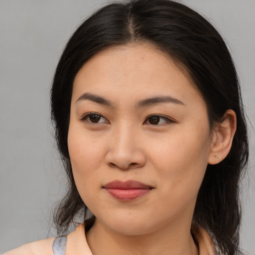 Joyful asian young-adult female with medium  brown hair and brown eyes