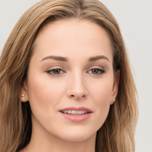 Joyful white young-adult female with long  brown hair and grey eyes