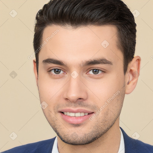 Joyful white young-adult male with short  brown hair and brown eyes