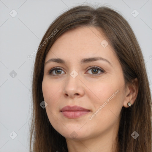 Joyful white young-adult female with long  brown hair and brown eyes