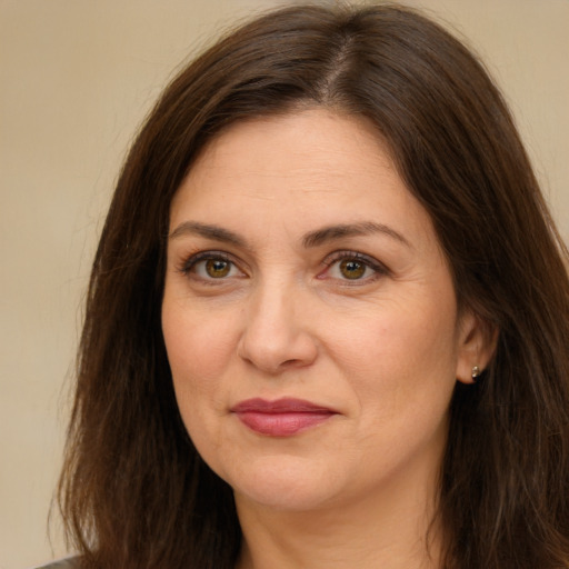 Joyful white adult female with long  brown hair and brown eyes