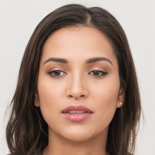 Joyful white young-adult female with long  brown hair and brown eyes