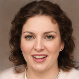 Joyful white young-adult female with medium  brown hair and green eyes