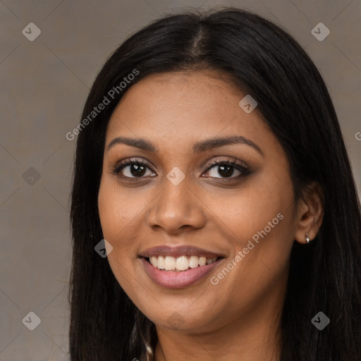 Joyful black young-adult female with long  black hair and brown eyes