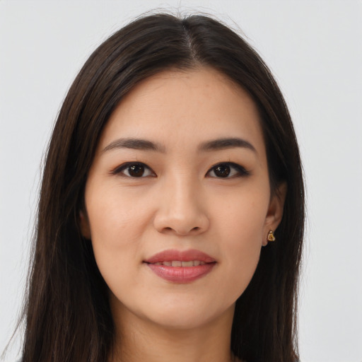 Joyful asian young-adult female with long  brown hair and brown eyes