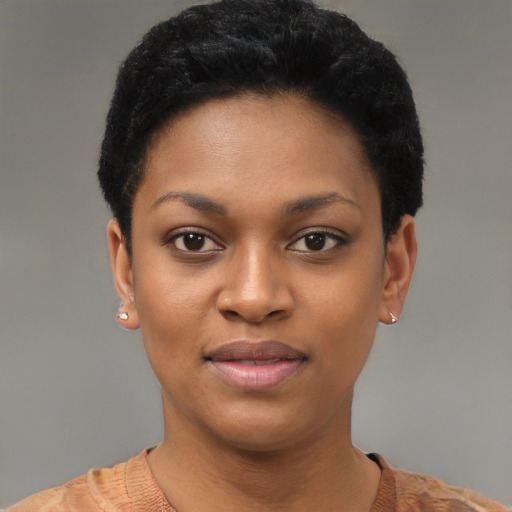 Joyful black young-adult female with short  black hair and brown eyes