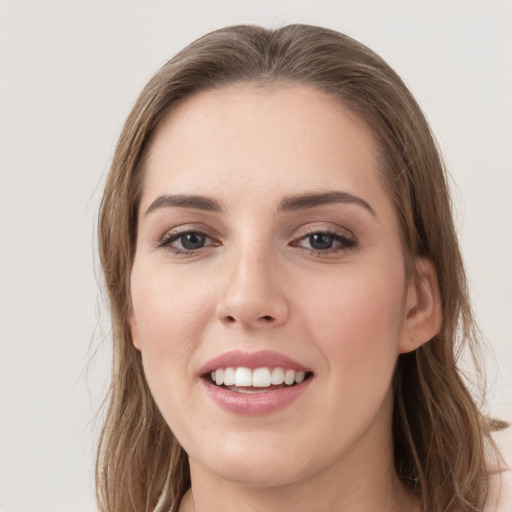 Joyful white young-adult female with long  brown hair and grey eyes