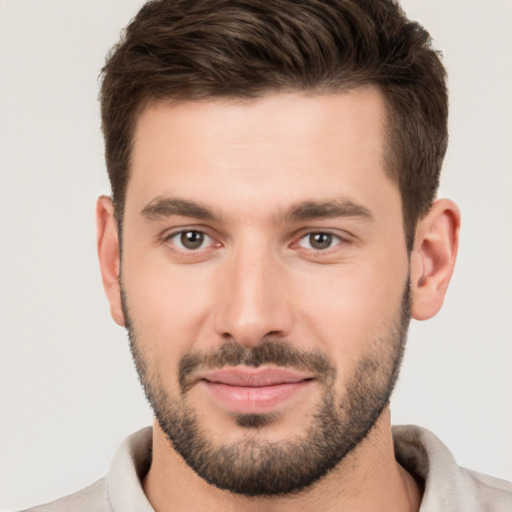 Joyful white young-adult male with short  brown hair and brown eyes