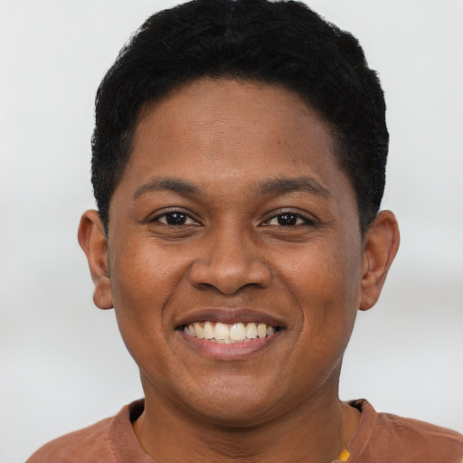 Joyful black young-adult female with short  black hair and brown eyes