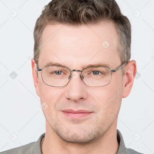 Joyful white adult male with short  brown hair and grey eyes