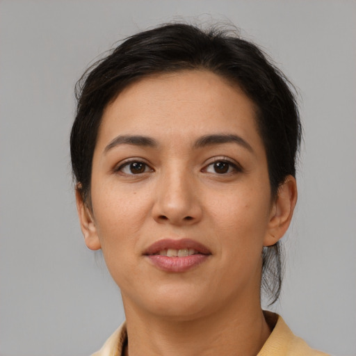 Joyful latino young-adult female with medium  brown hair and brown eyes